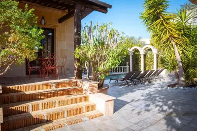 a patio with stairs and chairs and trees at REF 2134 - Cannes - Magnificent villa for rent in Cannes