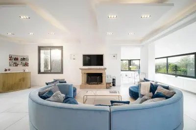 a living room with a blue couch and a fireplace at REF 2134 - Cannes - Magnificent villa for rent in Cannes