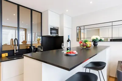 a kitchen with a counter with a bowl of fruit on it at My Ty Croisette Martinez YourHostHelper in Cannes
