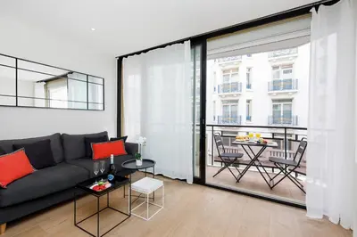 a living room with a couch and a large window at My Ty Croisette Martinez YourHostHelper in Cannes