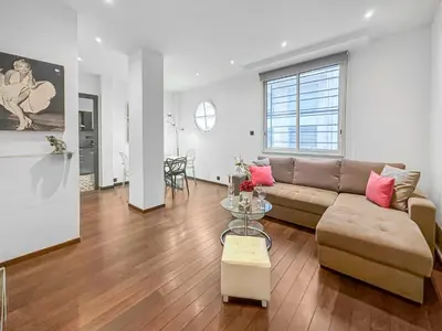 a living room with a couch and a table at La Perle de Cannes in Cannes