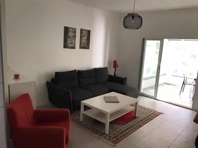 a living room with a couch and a table at Appartement au cœur de Cannes in Cannes