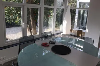 a glass table in a room with windows at Appartement au cœur de Cannes in Cannes
