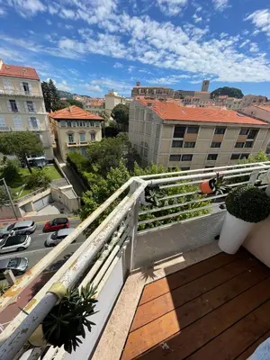 a balcony with a view of a city with buildings at Duplex en bord de mer avec piscine et parking in Cannes