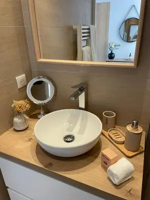 a bathroom with a white sink and a mirror at Duplex en bord de mer avec piscine et parking in Cannes