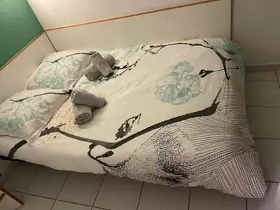 a bed with a blanket and two stuffed animals on it at Résidence de charme avec piscine à débordement in Cannes