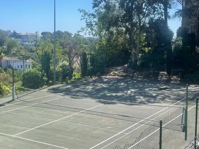 a view of a park from a balcony at Résidence de charme avec piscine à débordement in Cannes
