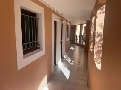 a hallway of a house with sun shining through the windows at Résidence de charme avec piscine à débordement in Cannes