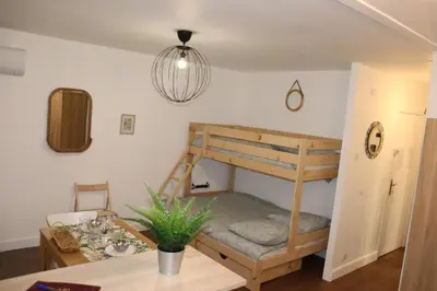 a room with a bunk bed and a table at Confort-Appartement cocooning *** in Le Cannet