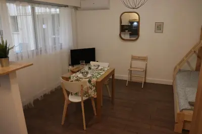 a dining room with a table and chairs at Confort-Appartement cocooning *** in Le Cannet