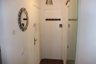 a hallway with a mirror and a white door at Confort-Appartement cocooning *** in Le Cannet