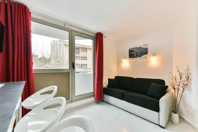a living room with a couch and a window at Stylish 2 rooms in the heart of Cannes in Cannes