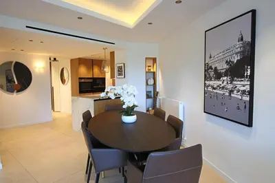 a dining room with a table and chairs at COMPLETELY RENOVATED APARTMENT ON BLD CROISETTE, 3 PARENTAL BEDROOMS in Cannes