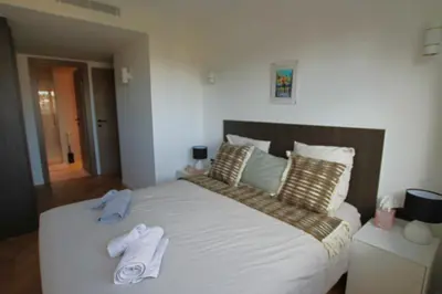 a bedroom with a bed with two towels on it at COMPLETELY RENOVATED APARTMENT ON BLD CROISETTE, 3 PARENTAL BEDROOMS in Cannes