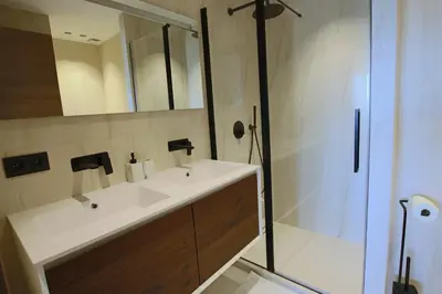 a bathroom with a white sink and a shower at COMPLETELY RENOVATED APARTMENT ON BLD CROISETTE, 3 PARENTAL BEDROOMS in Cannes