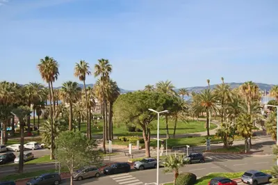 a parking lot with palm trees and cars parked at COMPLETELY RENOVATED APARTMENT ON BLD CROISETTE, 3 PARENTAL BEDROOMS in Cannes