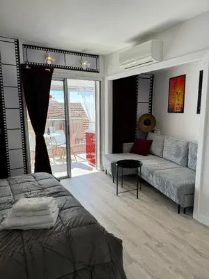 a living room with a bed and a couch at Toits du vieux port in Cannes