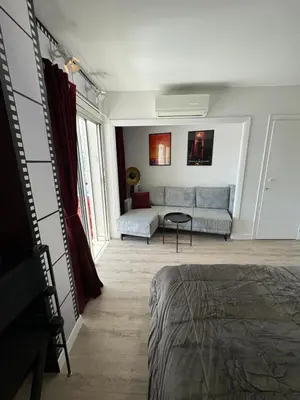 a living room with a couch and a table at Toits du vieux port in Cannes