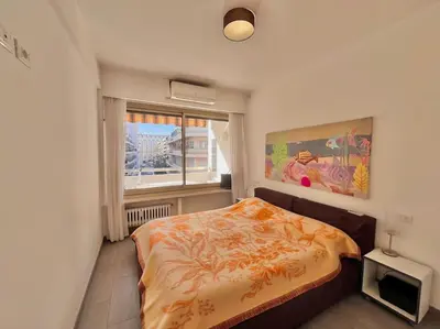 a bedroom with a bed and a window at Le Colony in Cannes
