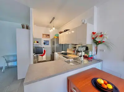 a kitchen with a bowl of fruit on a table at Le Colony in Cannes