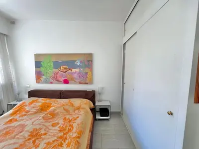 a bedroom with a bed and a painting on the wall at Le Colony in Cannes