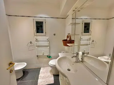a white bathroom with a sink and a toilet at Le Colony in Cannes