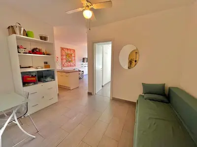 a living room with a green couch and a table at Le Colony in Cannes