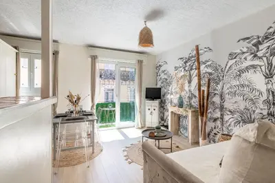 a living room with a large mural on the wall at Magnifique studio centre Cannes Vieux port-Croisette-Plages in Cannes