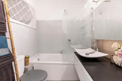 a white bathroom with a sink and a tub at Magnifique studio centre Cannes Vieux port-Croisette-Plages in Cannes