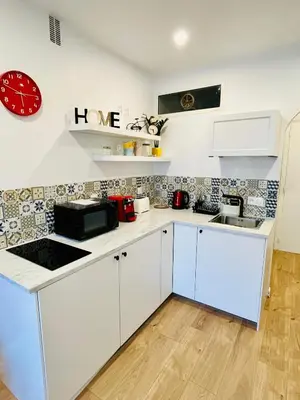 a living room with a tv and a mural on the wall at Luxury Studio à Cannes/Croisette in Cannes
