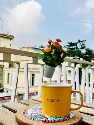a balcony with a table and chairs on the grass at Luxury Studio à Cannes/Croisette in Cannes