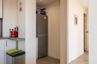 a kitchen with a refrigerator in a room at 3-Br Apartment Terrace steps from Beaches in Cannes