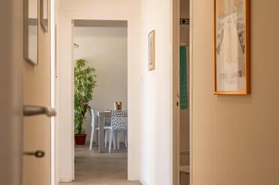 a hallway leading to a dining room with a table at 3-Br Apartment Terrace steps from Beaches in Cannes