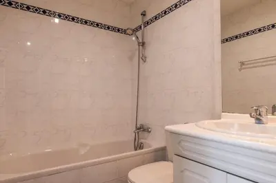 a bathroom with a tub and a toilet and a sink at 3-Br Apartment Terrace steps from Beaches in Cannes