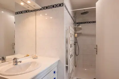 a bathroom with a sink and a shower at 3-Br Apartment Terrace steps from Beaches in Cannes