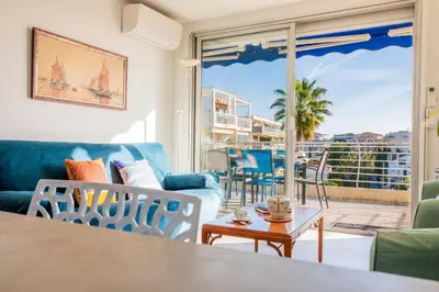 a living room with a couch and chairs and a table at 3-Br Apartment Terrace steps from Beaches in Cannes