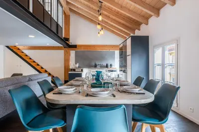 a dining room with a table and chairs at Spacious Duplex in the Heart of Cannes in Cannes