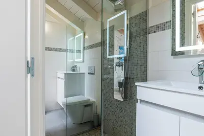 a bathroom with a toilet and a sink and a shower at Spacious Duplex in the Heart of Cannes in Cannes
