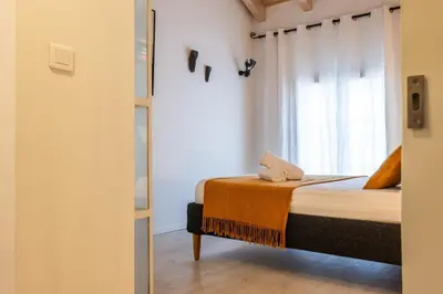 a bedroom with a bed and a window at Spacious Duplex in the Heart of Cannes in Cannes