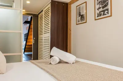 a bedroom with a bed with a towel on the floor at Spacious Duplex in the Heart of Cannes in Cannes