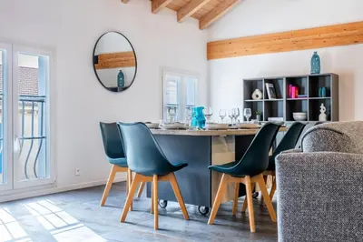 a kitchen with a counter and chairs in a room at Spacious Duplex in the Heart of Cannes in Cannes