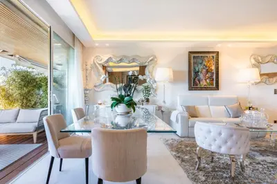 a living room with a table and chairs at Somptuous 3 bedroom with sea-view on the Croisette in Cannes