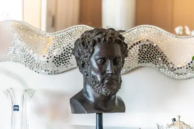 a bronze bust of a man with a comb at Somptuous 3 bedroom with sea-view on the Croisette in Cannes