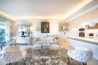 a living room with a couch and a table at Somptuous 3 bedroom with sea-view on the Croisette in Cannes