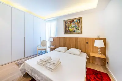 a bedroom with a white bed with towels on it at Somptuous 3 bedroom with sea-view on the Croisette in Cannes