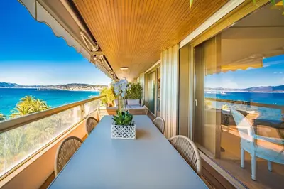 a table on a balcony with a view of the ocean at Somptuous 3 bedroom with sea-view on the Croisette in Cannes