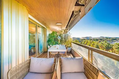 a balcony with chairs and a table on a building at Somptuous 3 bedroom with sea-view on the Croisette in Cannes