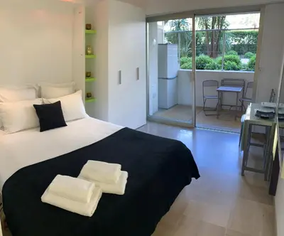 a bedroom with a large bed with two towels on it at Studio Cannes Croisette in Cannes