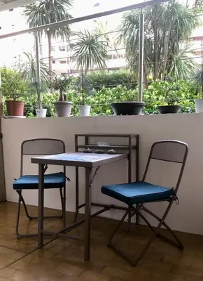 a table and two chairs sitting in front of a window at Studio Cannes Croisette in Cannes