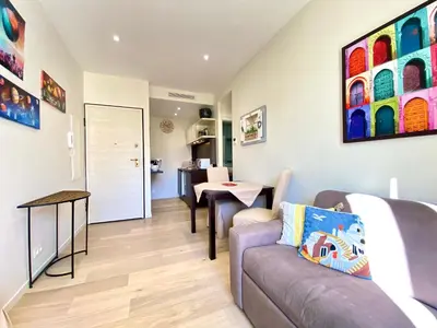 a living room with a couch and a table at Le 74 By SCLS Locations in Cannes
